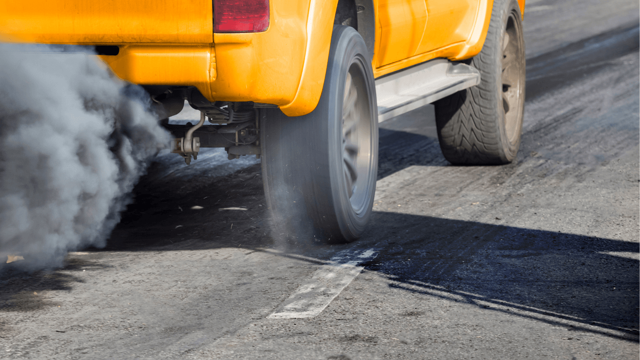 Dirty exhaust from yellow pickup truck